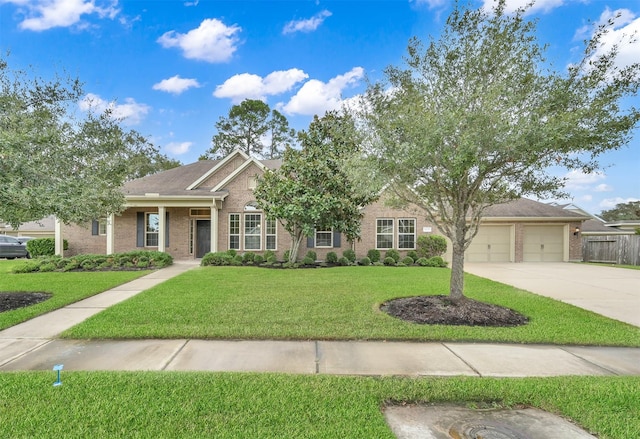 view of front of home with a garage and a front lawn