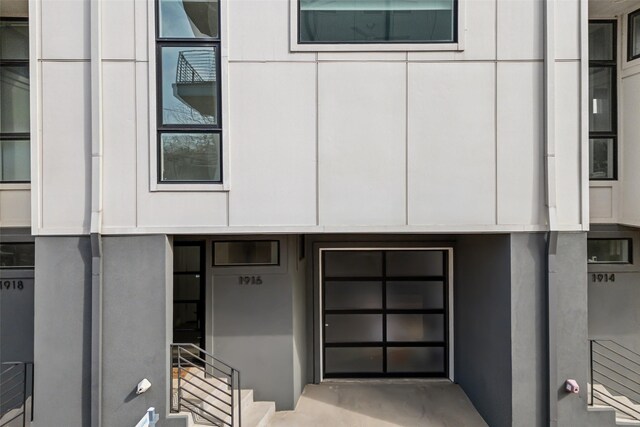 property entrance featuring board and batten siding