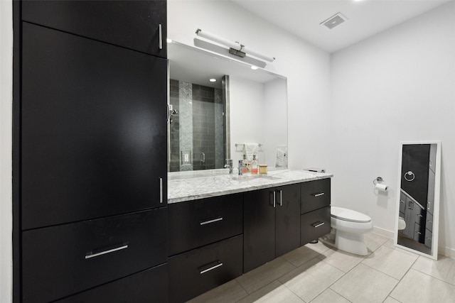 full bathroom with a stall shower, baseboards, visible vents, toilet, and vanity