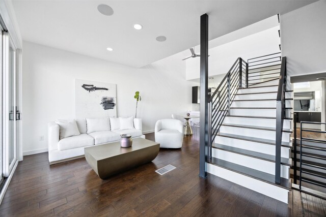 living area featuring recessed lighting, wood-type flooring, visible vents, and stairs