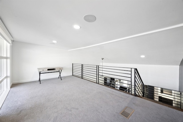 additional living space featuring carpet floors, baseboards, visible vents, and recessed lighting