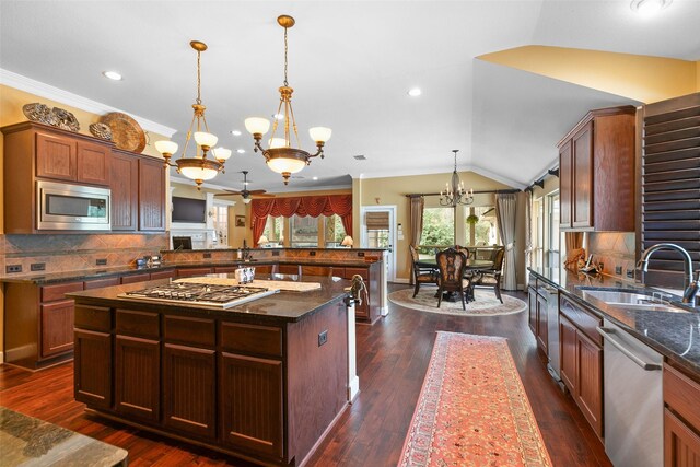 7514 Saddle Blanket Dr, Waller, TX 77484 - kitchen featuring a sink, a chandelier, stainless steel appliances, a peninsula, and tasteful backsplash