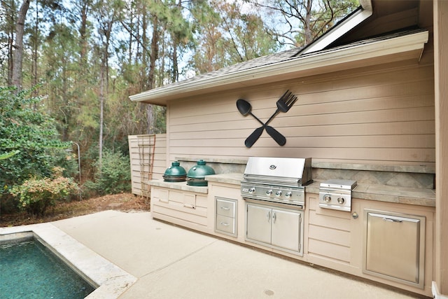 view of patio / terrace featuring an outdoor kitchen, a grill, and ceiling fan