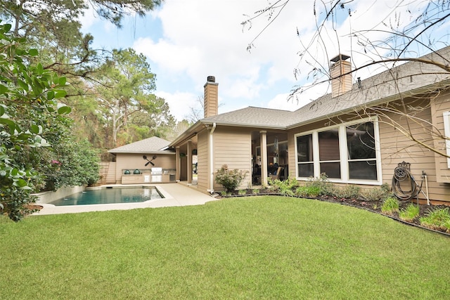 back of property with a patio and a lawn