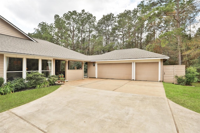 single story home featuring a garage and a front yard