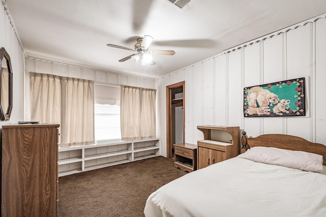 bedroom featuring ceiling fan and dark colored carpet