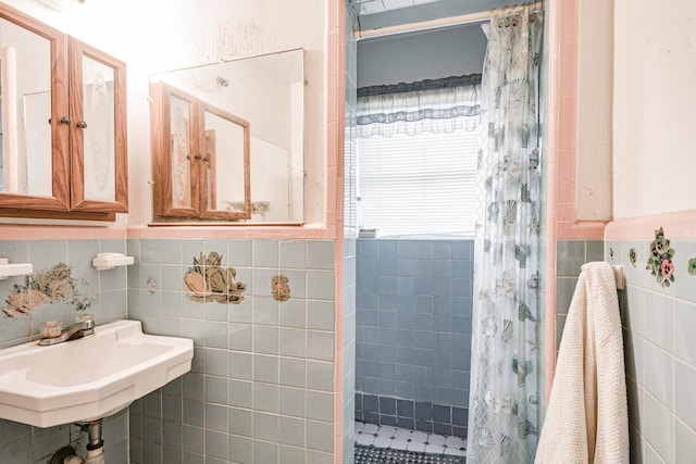 bathroom with sink, tile walls, and a shower with curtain