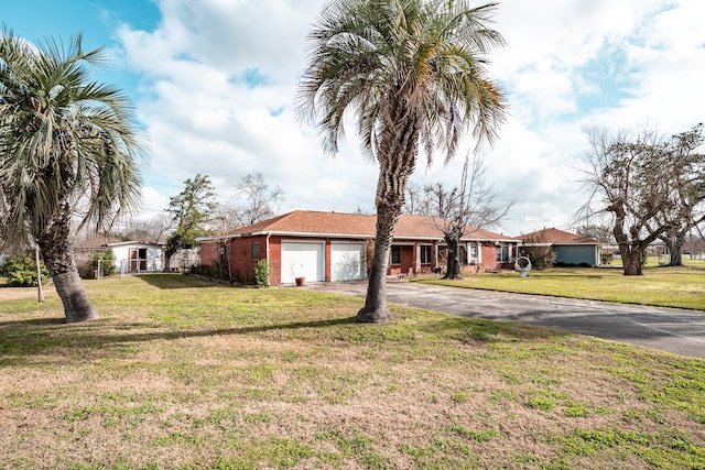 single story home featuring a garage and a front lawn