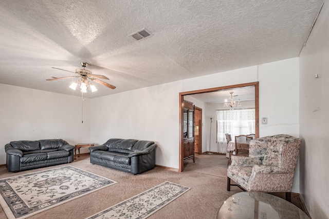 living room with ceiling fan with notable chandelier, carpet, and a textured ceiling