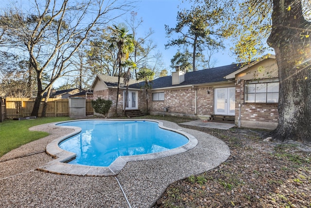 view of pool with french doors