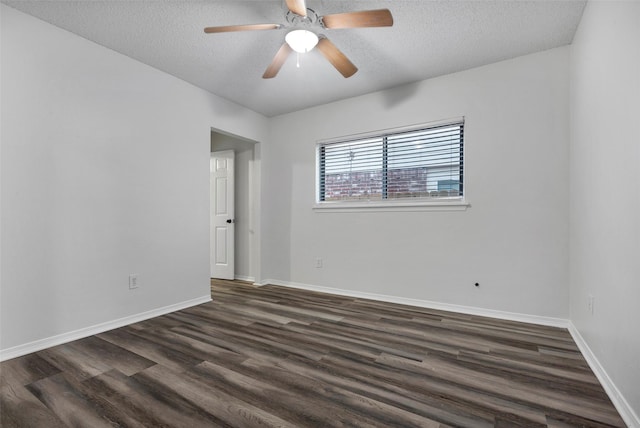 empty room featuring ceiling fan, dark hardwood / wood-style floors, and a textured ceiling