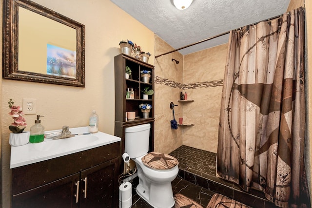 full bath with a textured ceiling, vanity, a tile shower, and toilet