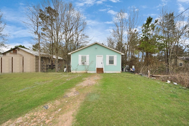 view of front of house featuring entry steps, a front yard, and cooling unit