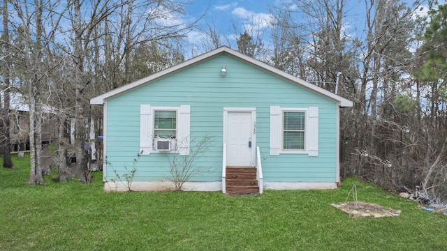 bungalow-style home featuring entry steps and a front lawn