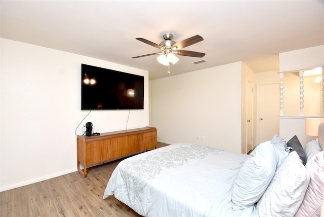 bedroom with ceiling fan and light hardwood / wood-style floors