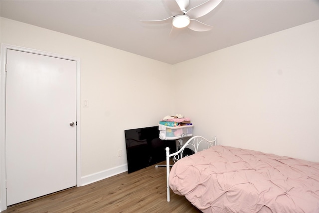 bedroom featuring hardwood / wood-style flooring and ceiling fan