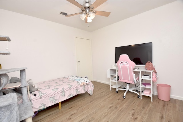 bedroom with ceiling fan and light hardwood / wood-style floors