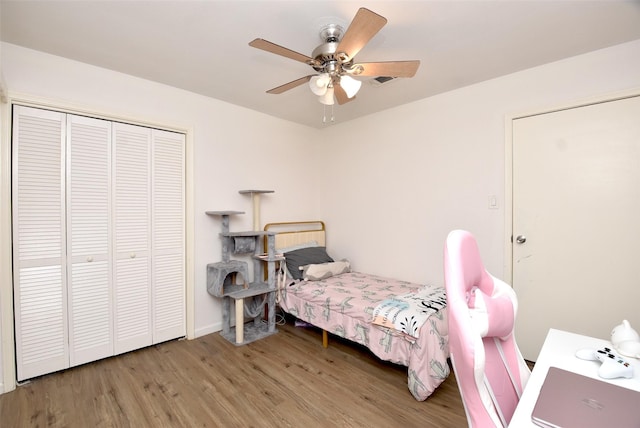 bedroom with wood-type flooring, a closet, and ceiling fan