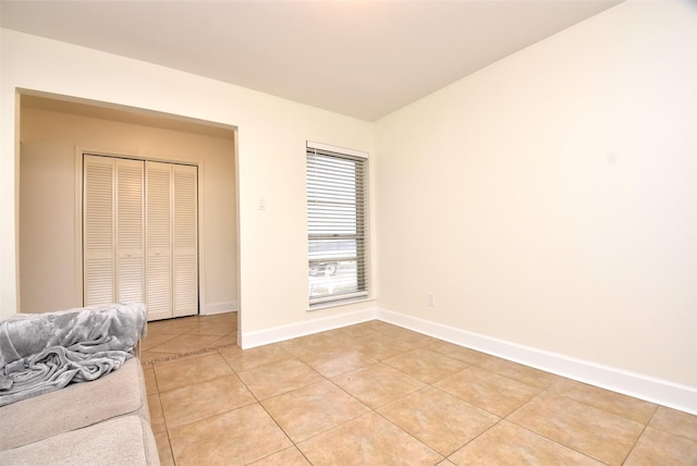 tiled bedroom with a closet