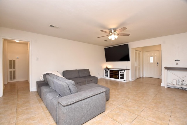 tiled living room featuring ceiling fan