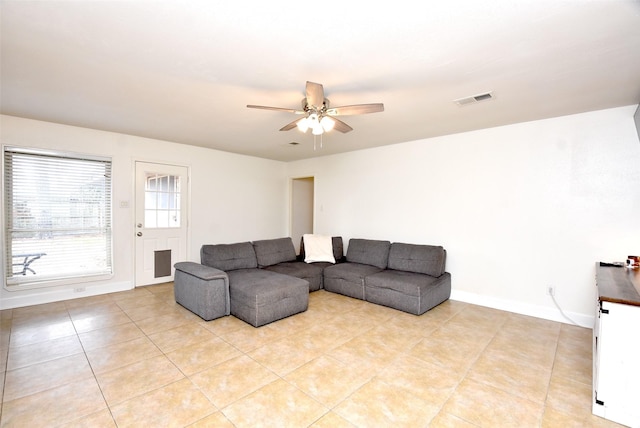 tiled living room featuring ceiling fan