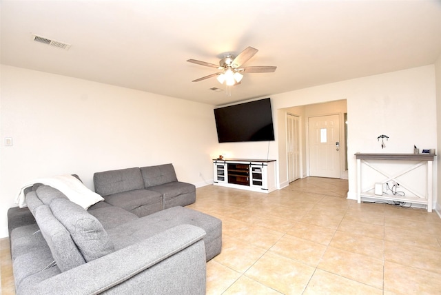 tiled living room featuring ceiling fan