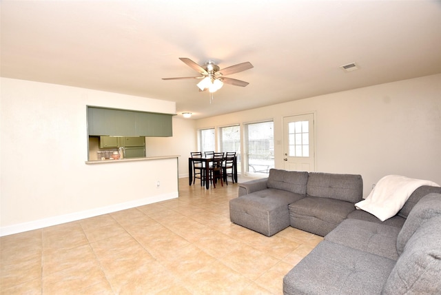 tiled living room with ceiling fan