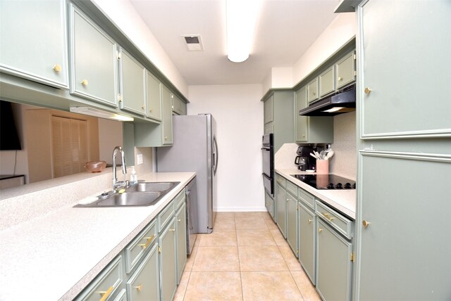 kitchen featuring light tile patterned flooring, sink, kitchen peninsula, green cabinets, and black appliances