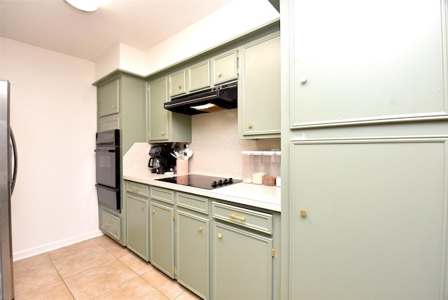 kitchen with green cabinets, light tile patterned floors, decorative backsplash, and black appliances