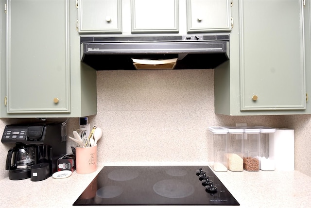 kitchen with black electric cooktop, tasteful backsplash, and range hood