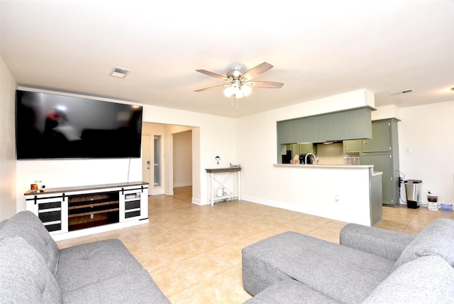 tiled living room featuring ceiling fan