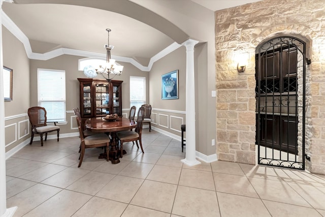 dining space with crown molding, a wealth of natural light, and light tile patterned floors