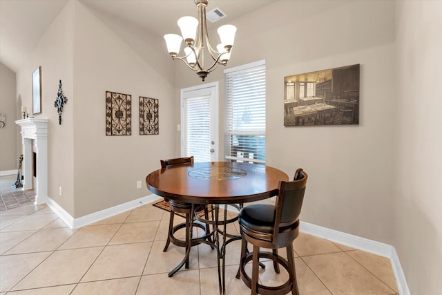 dining room featuring lofted ceiling, light tile patterned floors, and a chandelier