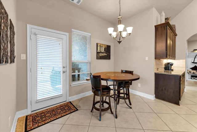 dining room featuring light tile patterned floors and a chandelier