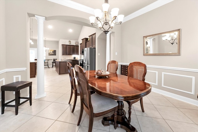 dining space featuring light tile patterned floors, crown molding, a notable chandelier, and ornate columns