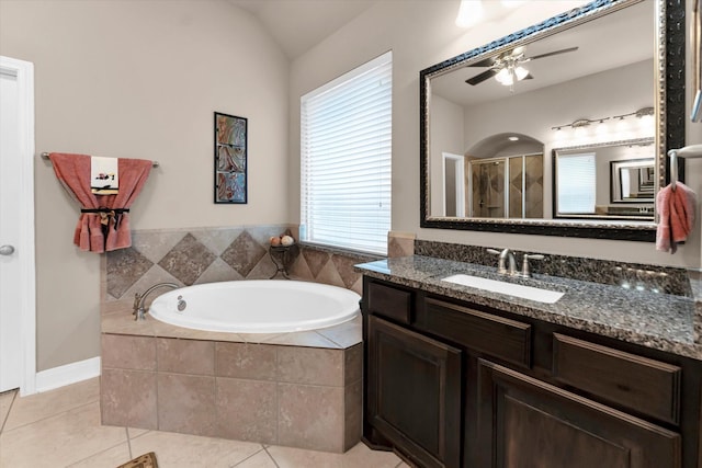 bathroom with vaulted ceiling, shower with separate bathtub, tile patterned flooring, vanity, and ceiling fan