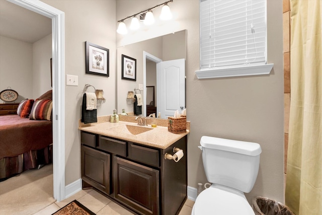 bathroom featuring tile patterned flooring, vanity, and toilet