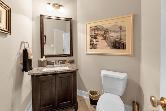 bathroom featuring vanity, tile patterned floors, and toilet