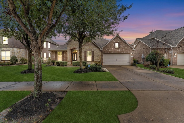 view of front facade featuring a garage and a yard