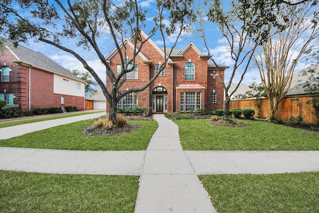 view of front property featuring a garage and a front lawn