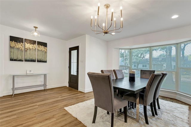 dining room with a chandelier and light wood-type flooring