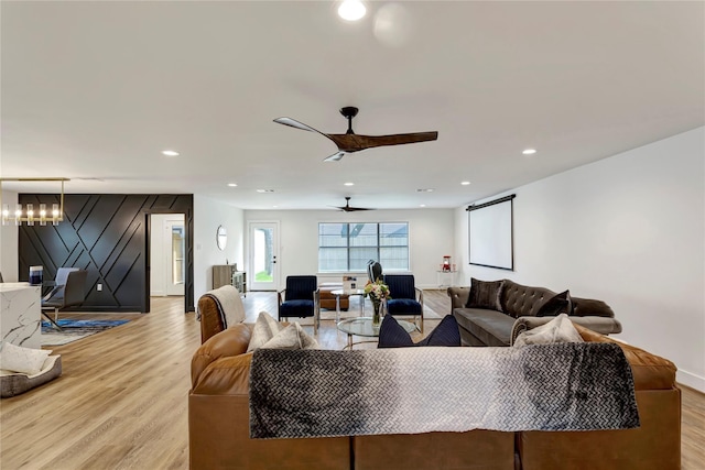 living room with ceiling fan and light wood-type flooring