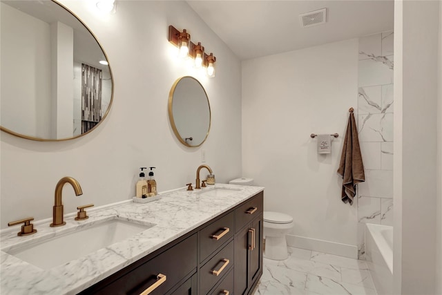 bathroom featuring a tub to relax in, toilet, and vanity