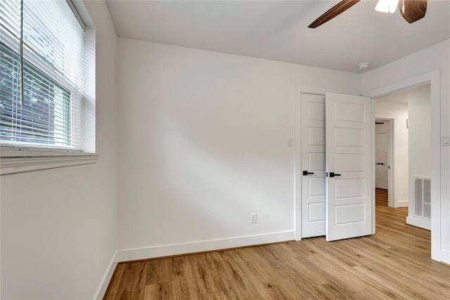 unfurnished bedroom featuring ceiling fan and light wood-type flooring