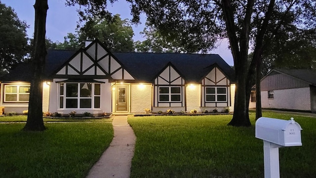 2114 Eaglerock Dr, Houston, TX 77080 - tudor home featuring a front lawn and stucco siding