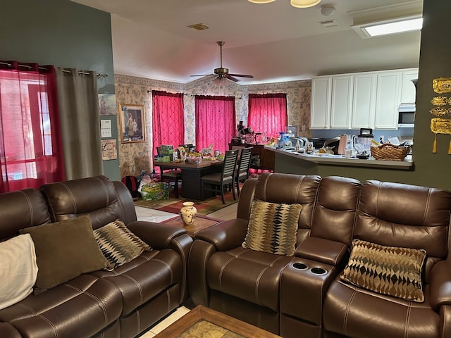 home theater room featuring vaulted ceiling and ceiling fan