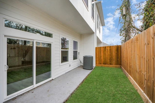 view of yard with a fenced backyard and cooling unit