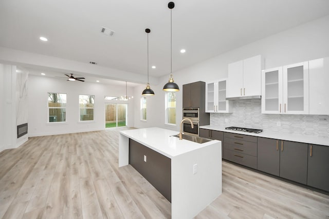 kitchen featuring visible vents, white cabinets, appliances with stainless steel finishes, light countertops, and pendant lighting