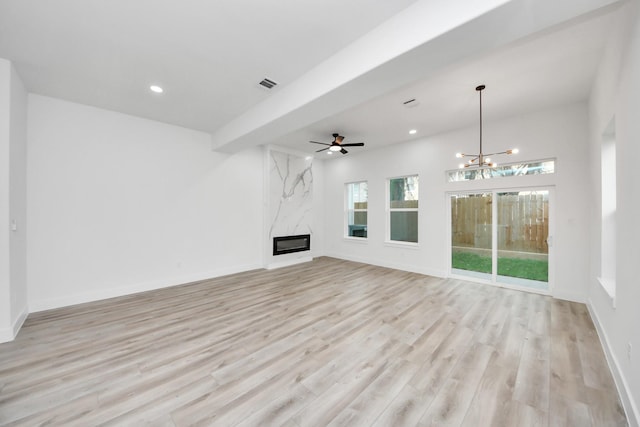 unfurnished living room featuring light wood finished floors, a premium fireplace, visible vents, and recessed lighting