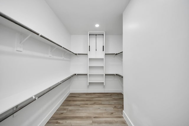 walk in closet with light wood-type flooring